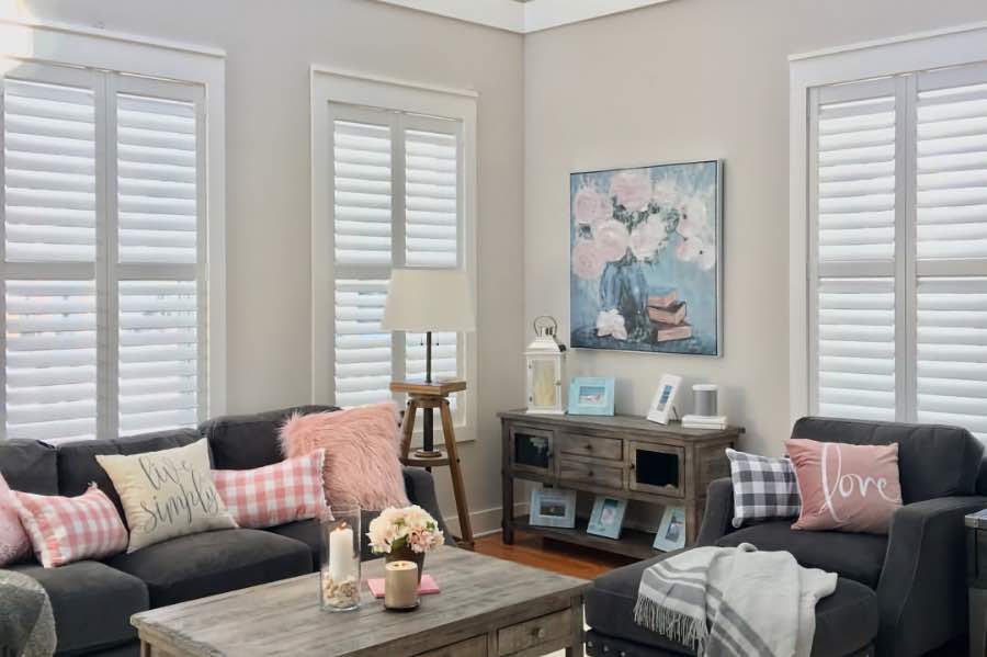 White Polywood shutters with hidden tilt rods on windows in a living room